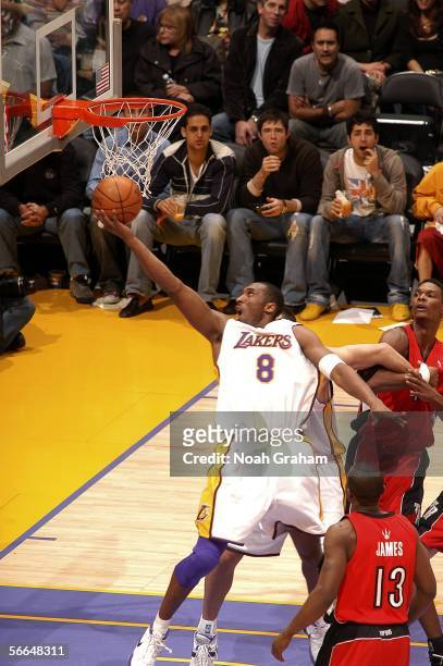 Kobe Bryant of the Los Angeles Lakers shoots against Chris Bosh and Mike James of the Toronto Raptors on January 22, 2006 at Staples Center in Los...