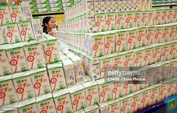 Local resident shops for milk for the upcoming Chinese new year at a newly opened supermarket on January 22, 2006 in Haikou of Hainan Province, south...
