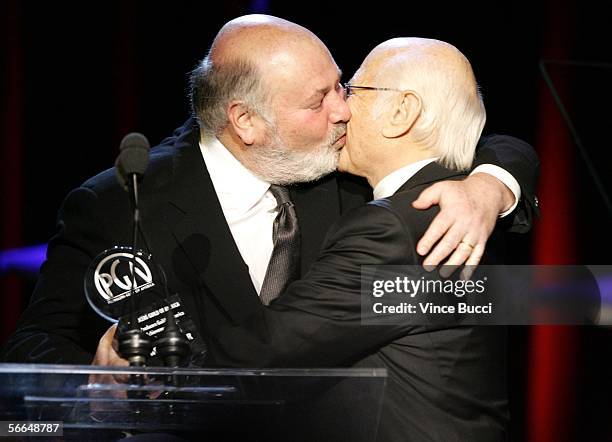 Director Rob Reiner kisses Producer Norman Lear as he presents him the Producers Guild Achievement Award in Television award onstage during the 2006...