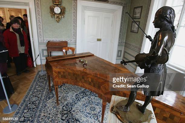 Visitor pauses to look at an original harpsichord and a small statue of Austrian composer Wolfgang Amadeus Mozart in the room where Mozart stayed and...