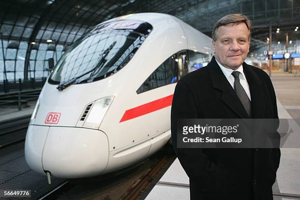 Hartmut Mehdorn, head of the German state railways company Deutsche Bahn AG, poses next to a Deutsche Bahn ICE high-speed train at a promotional...