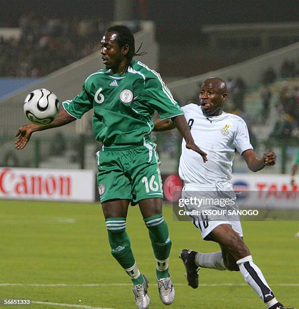 Nigerian player Joseph Enakarhire vies with Ghanaian player Abubakari Yakubu during their African Nations Cup football match at al-Masri club stadium...