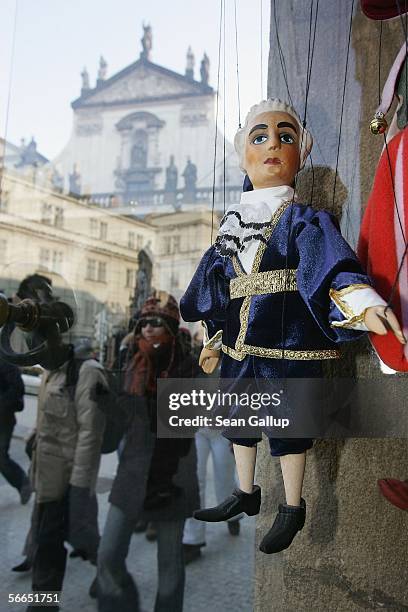 People walk past a marionette of Austrian composer Wolfgang Amadeus Mozart at a shop January 23, 2006 in Prague, Czech Republic. Mozart stayed and...