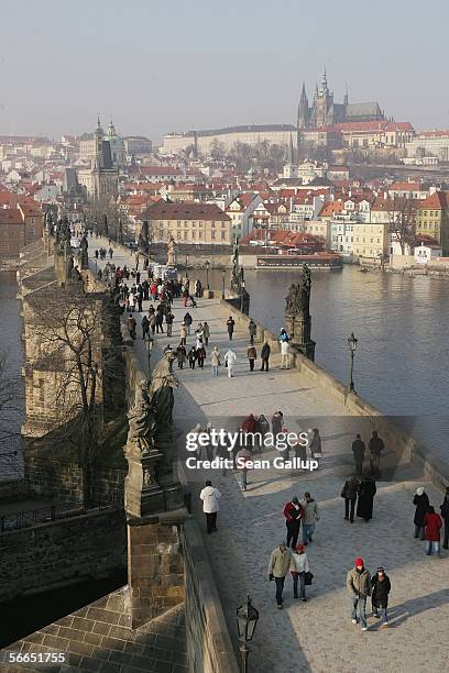 People cross the Charles Bridge January 23, 2006 in central Prague, Czech Republic. Austrian composer Wolfgang Amadeus Mozart stayed and composed in...