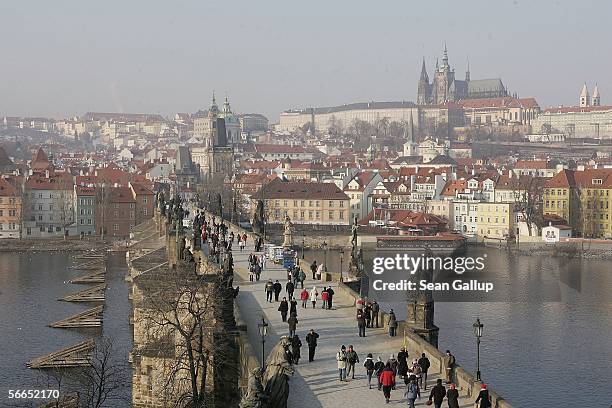 People cross the Charles Bridge January 23, 2006 in central Prague, Czech Republic. Austrian composer Wolfgang Amadeus Mozart stayed and composed in...