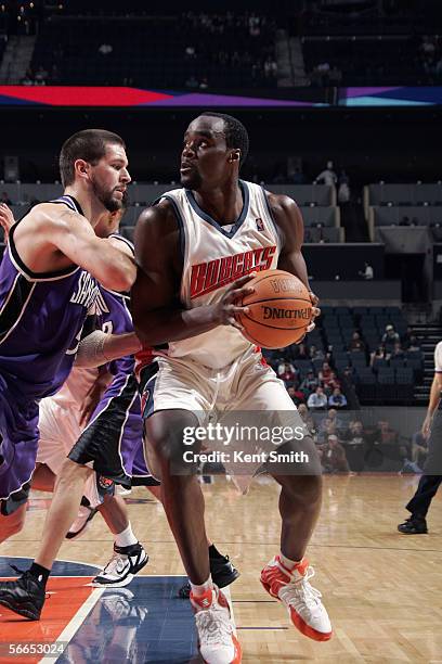 Emeka Okafor of the Charlotte Bobcats moves the ball against Brad Miller of the Sacramento Kings during the game on December 19, 2005 at the...