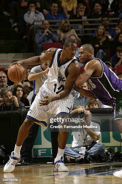 Dwight Howard of the Orlando Magic is defended by Jamaal Magloire of the Milwaukee Bucks on December 26, 2005 at TD Waterhouse Centre in Orlando,...