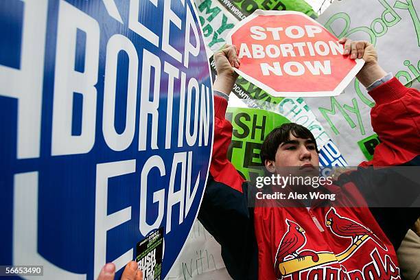 Pro-life activist Brad Luberda of St. Louis displays a sign against a group of pro-choice activists in front of the U.S. Supreme Court January 23,...