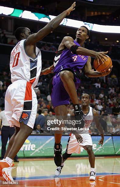 Chris Bosh of the Toronto Raptors goes up against Emeka Okafor of the Charlotte Bobcats during the game on December 10, 2005 at the Charlotte Bobcats...