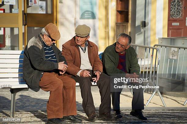 three old men discuss matters - alentejo photos et images de collection