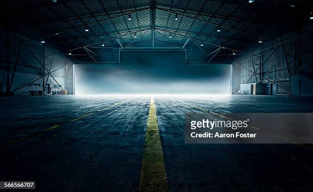 airplane hangar - dark background light stock-fotos und bilder