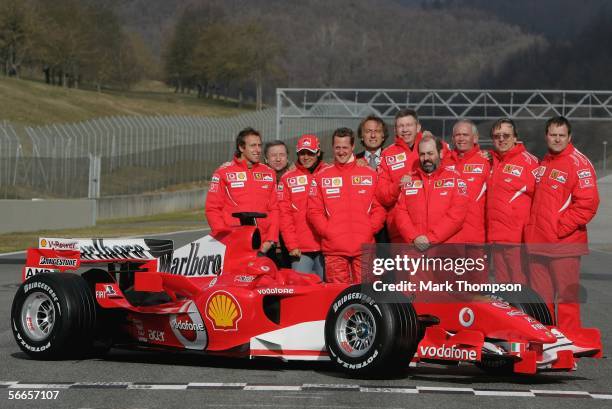 Michael Schumacher of Germany and Fellipe Massa of Brazil pose with the Ferrari technical and design team of the 248 F1 during the launch of the new...