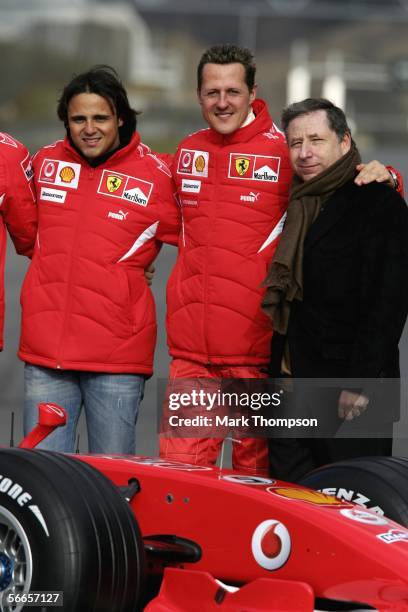 Michael Schumacher of Germany and Fellipe Massa of Brazil and team principal Jean Todt of France pose with the Ferrari 248 F1 during the launch of...