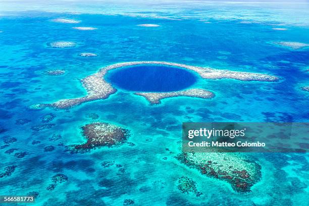 aerial of the blue hole, lighthouse reef, belize - belize stock-fotos und bilder