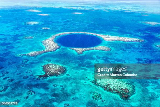 aerial of the blue hole, lighthouse reef, belize - sinkhole foto e immagini stock