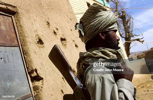 Bugti guerrilla stands near shrapnel damage from a mortar attack January 24, 2006 in Dera Bugti, the province of Balochistan, Pakistan. The Bugti and...