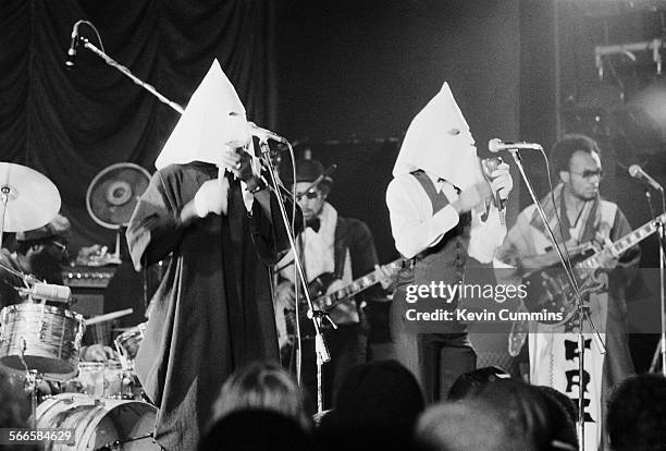 Singers Michael Riley and David Hinds performing, in Ku Klux Klan hoods, with English roots reggae band Steel Pulse at the Elizabethan Hall, Belle...