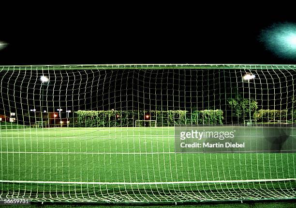 football field at night - soccer goal stock-fotos und bilder