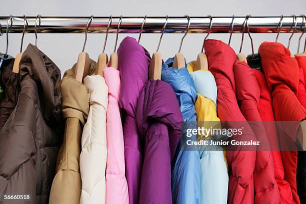 numerous colorful jackets on a rack - casaco azul imagens e fotografias de stock