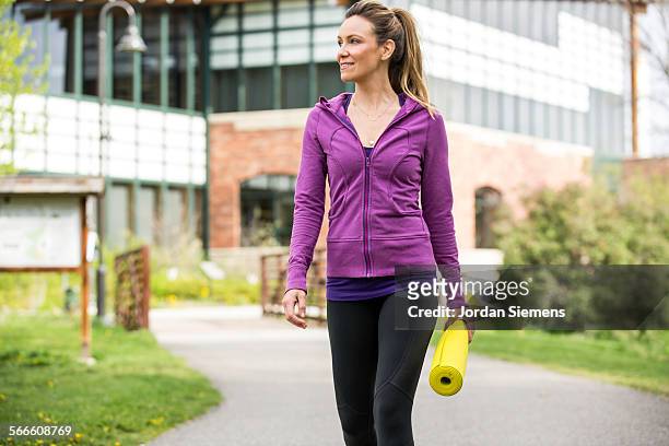 a woman doing yoga in a park. - sportswear stock pictures, royalty-free photos & images