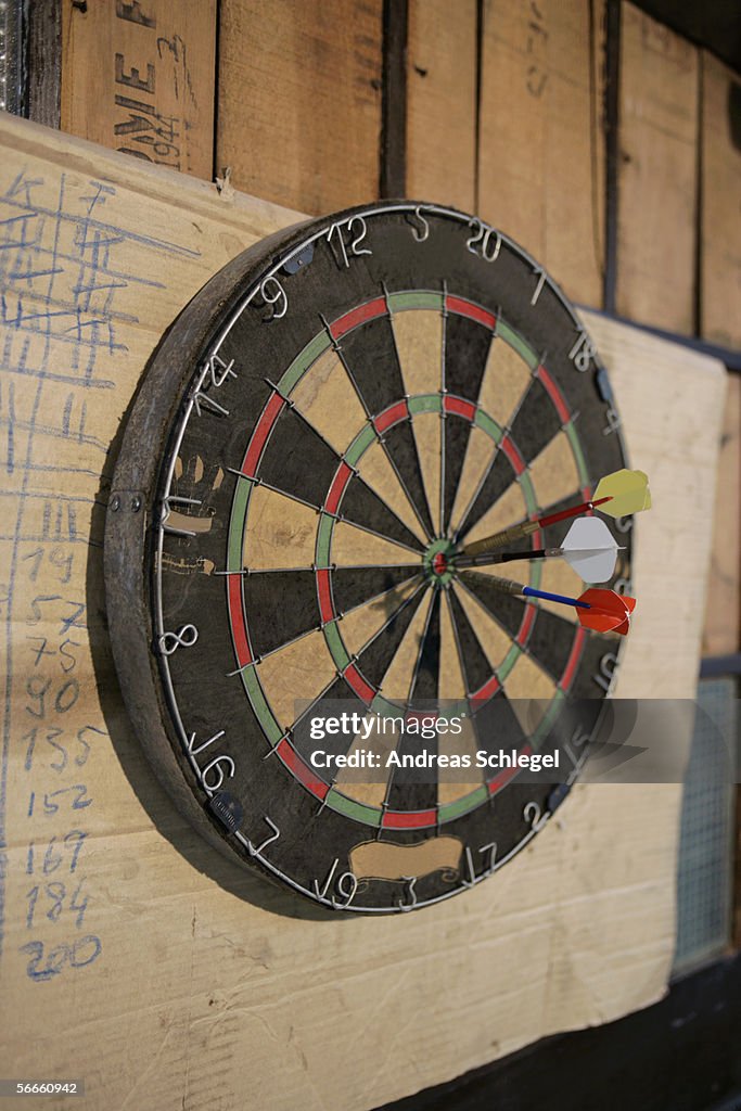 Side view of a dartboard with darts on the center