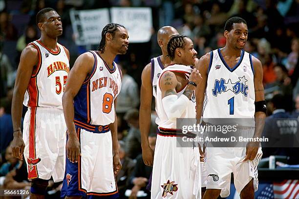 Dikembe Mutombo#55, Latrell Sprewell, Glenn Robinson, Allen Iverson, and Tracy McGrady of the Eastern Conference All-Stars talk during the 2002 NBA...