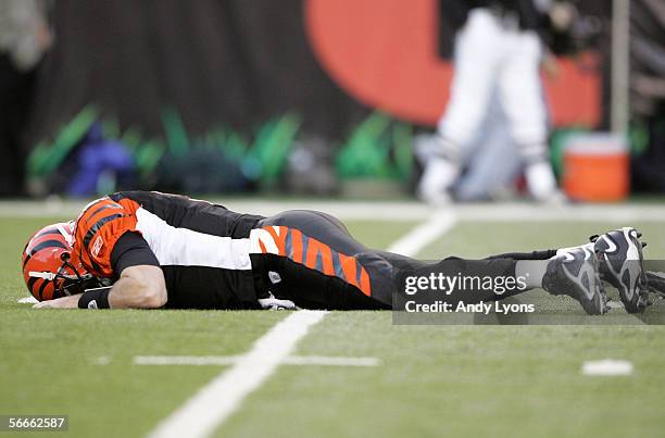 Quarterback Carson Palmer of the Cincinnati Bengals lays on the ground after being hit in the knee on the first drive of the AFC Wild Card Playoff...