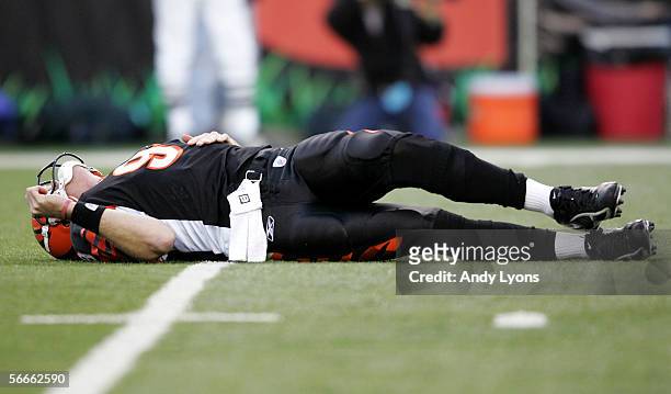 Quarterback Carson Palmer of the Cincinnati Bengals lays on the ground after being hit in the knee on the first drive of the AFC Wild Card Playoff...
