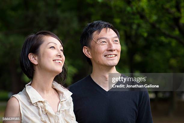 portrait of a couple in the park - mid adult couple bildbanksfoton och bilder