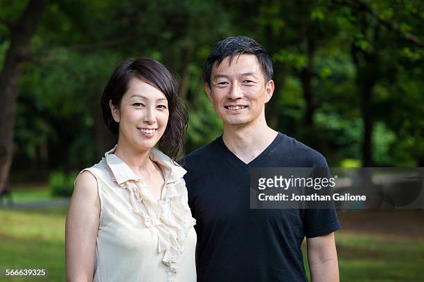portrait of a smiling couple in the park - 夫婦 ストックフォトと画像