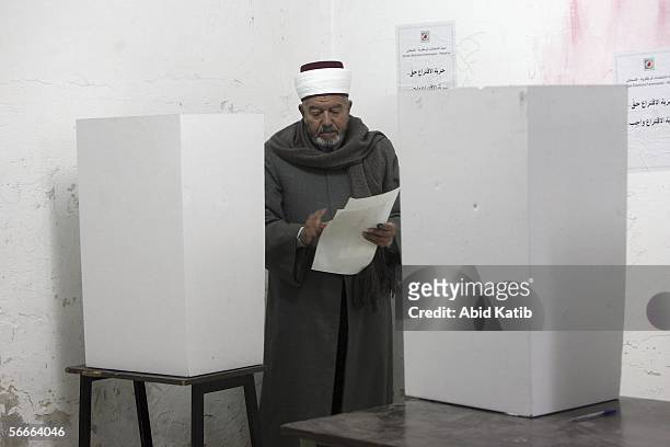 Palestinian muslim Imam votes for the Palestinian legislative candidates , in the U.N. School Alef which is being used as an election station,January...