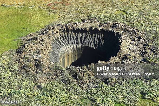 An aerial view from onboard a helicopter taken on August 25, 2014 shows a crater on the Yamal Peninsula, northern Siberia. Russian scientists have...