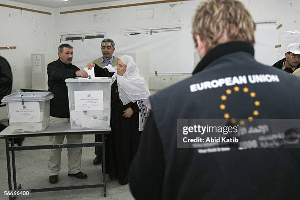 Member of a European Union mission to observe the parliamentary elections in the West Bank and Gaza monitor Palestinians as they vote for the...