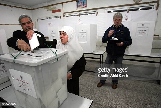 Member of a European Union mission to observe the parliamentary elections in the West Bank and Gaza monitors Palestinians as they vote for the...