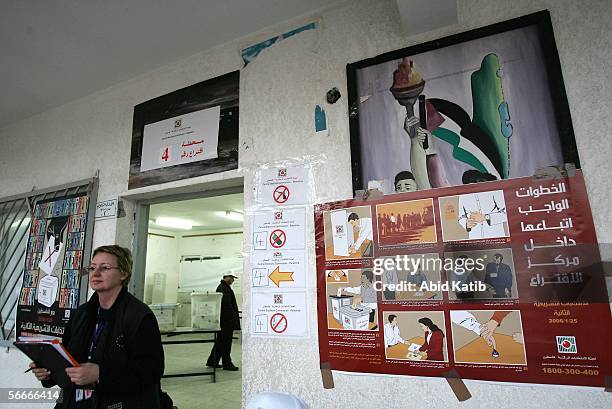 Member of a European Union mission to observe the parliamentary elections in the West Bank and Gaza monitors Palestinians as they vote for the...