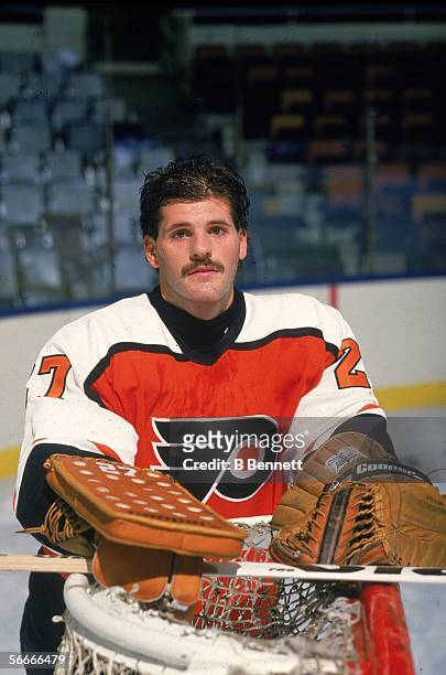 Publicity photograph of Canadian professional hockey player Ron Hextall, goalie for the Philadelphia Flyers, who poses near the goal post, 1988 -...