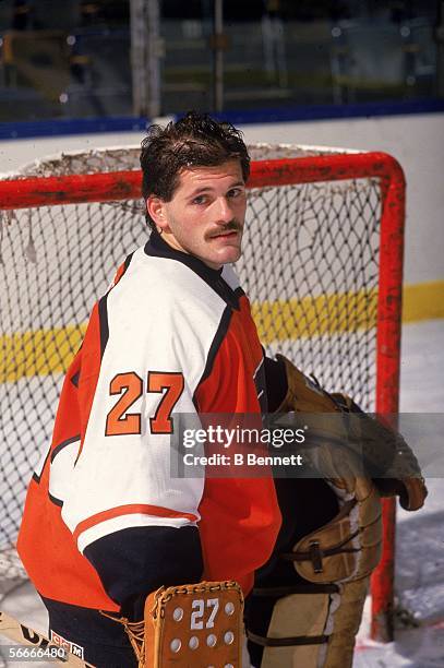 Publicity photograph of Canadian professional hockey player Ron Hextall, goalie for the Philadelphia Flyers, who poses on the ice in front of the...