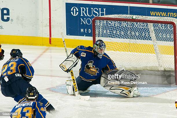 Jason Bacashihua of the Peoria Rivermen makes a save against the Chicago Wolves at Allstate Arena on December 11, 2005 in Rosemont, Illinois. The...