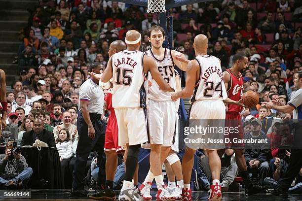 Vince Carter of the New Jersey Nets talks to his teammates Nenad Krstic and Richard Jefferson during the game against the Cleveland Cavaliers on...