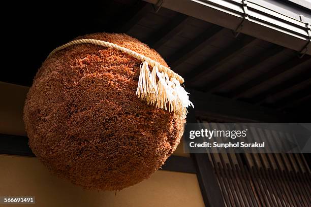 cedar leaves ball hung outside sake brewery - sake stock-fotos und bilder