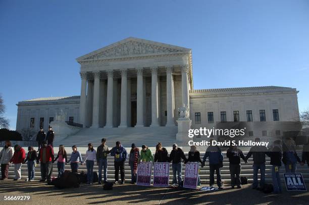 Dozens of people form a circle to share prayer during the March for Life prayer vigil in front of the Supreme court building on January 22, 2006 in...