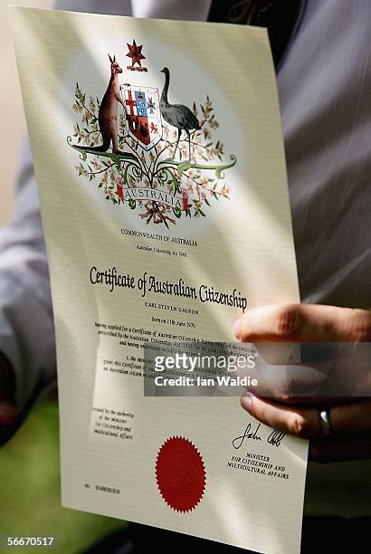 New Australian citizen holds his certificate after a citizenship ceremony on Australia Day January 26, 2006 in Sydney, Australia. Over 14,000 people...