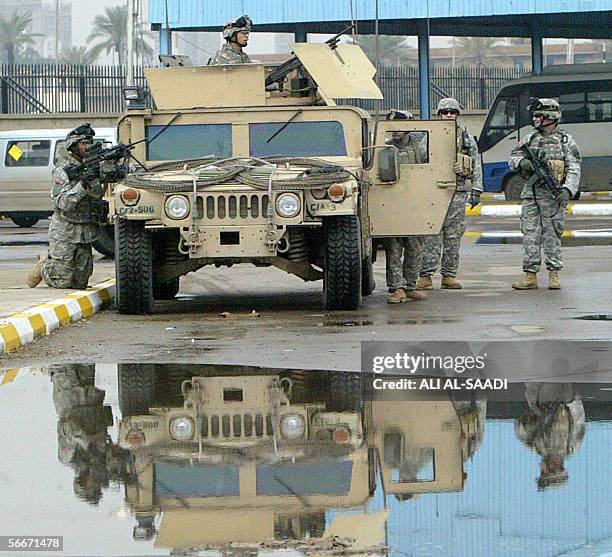 Soldiers take position prior to the arrival of Iraqis released from the notorious Abu Ghraib jail in Baghdad 26 January 2006. More than 400 detainees...