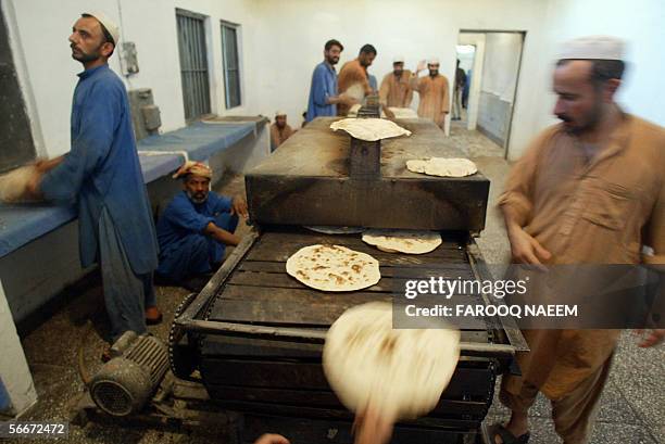 Pakistani prisoners prepare bread in the kitchens of Adyala Jail in Rawalpindi, 26 January 2006. Due to slow court procedures it usually takes...