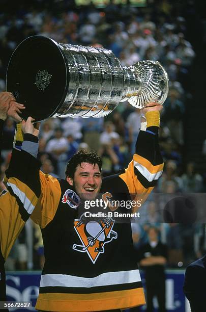 Canadian profession hockey player Mario Lemieux of the Pittsburgh Penguins hoists the Stanley Cup over his head as he celebrates the Pens' first...