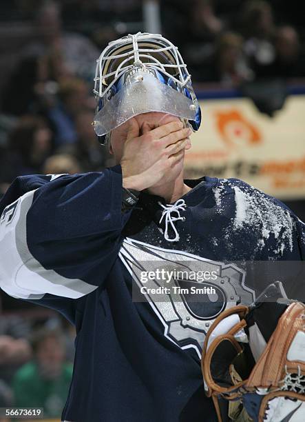 Goaltender Jussi Markkanen of the Edmonton Oilers wipes his eyes during the game against the Ottawa Senators on January 14, 2006 at Rexall Place in...