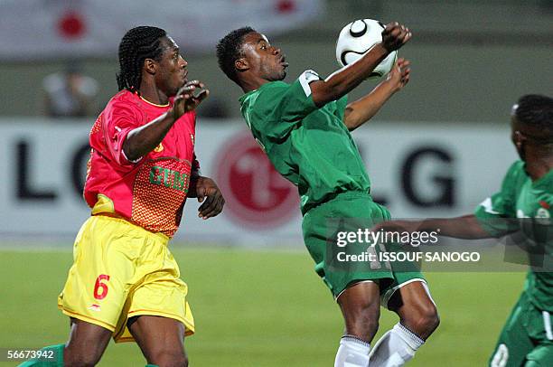 Zambian player Andrew Sinkala vies with Guinean player Pablo Thiam during their Group C African Nations Cup football match at the Haras el-Hodoud...