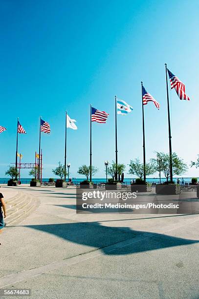 row of american flags fluttering, chicago, illinois, usa - navy pier stock pictures, royalty-free photos & images
