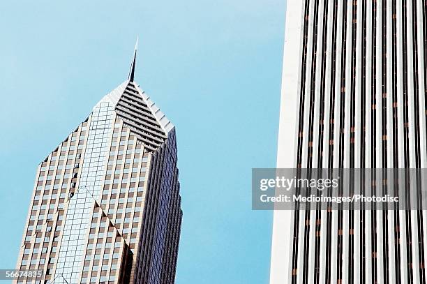 low angle view of skyscrapers in a city, two prudential plaza and the aon center, chicago, illinois, usa - aon center chicago stock pictures, royalty-free photos & images