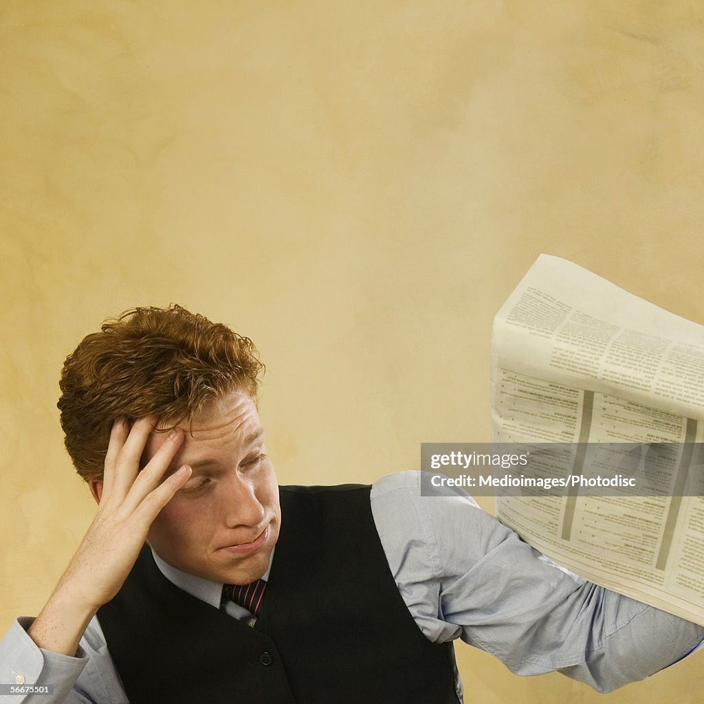 Close-up of a businessman holding a newspaper